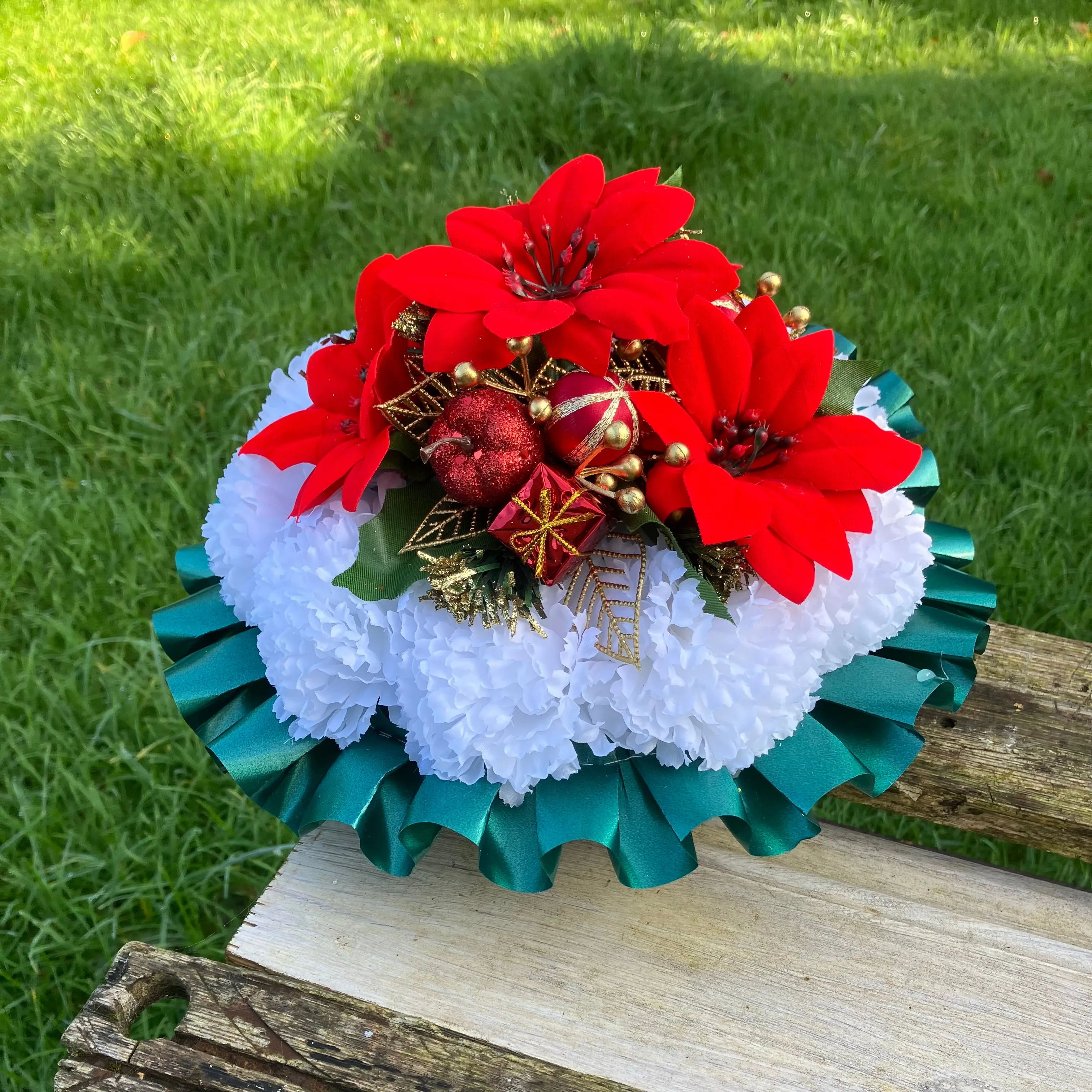 a memorial Christmas grave side posy of red poinsettia & baubles