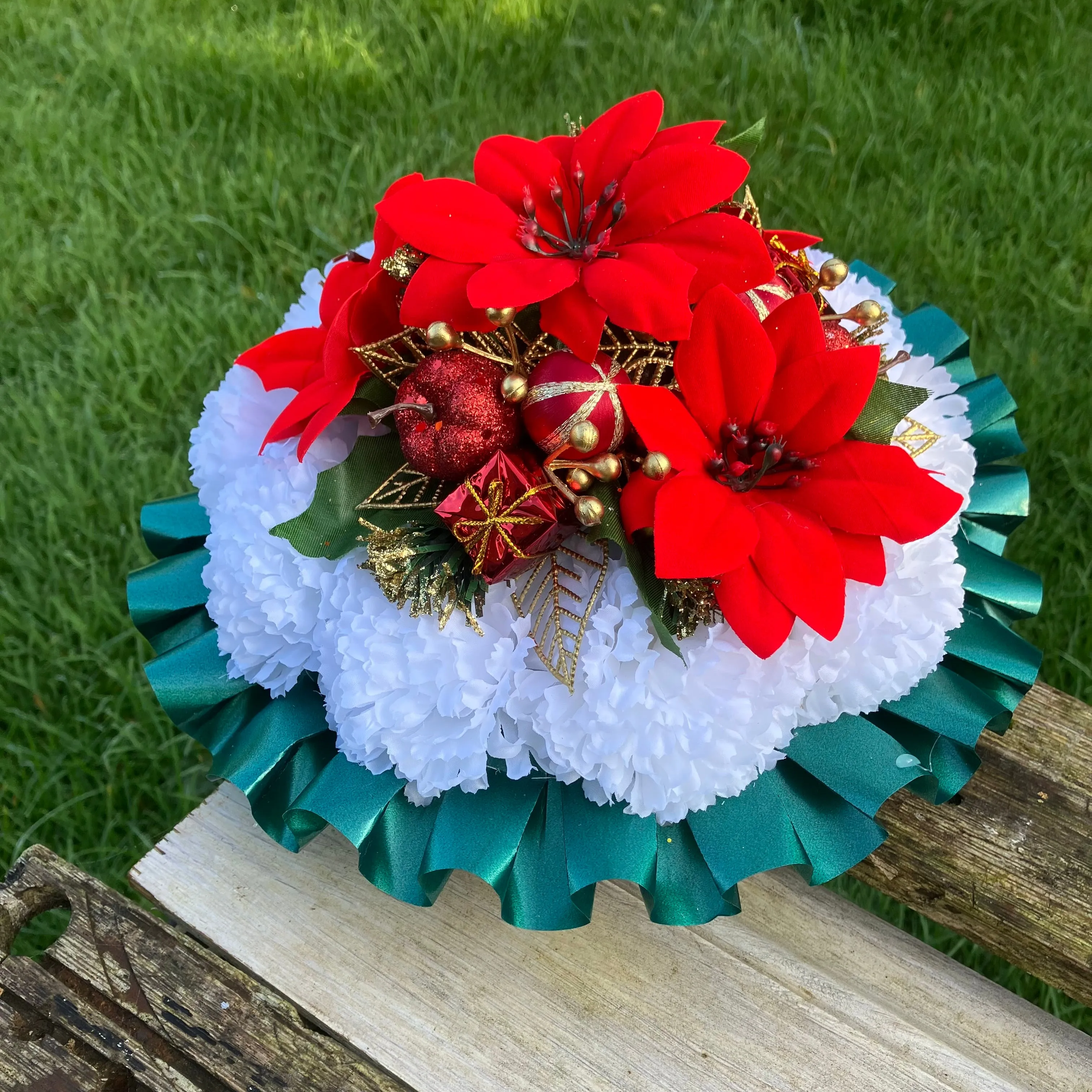 a memorial Christmas grave side posy of red poinsettia & baubles