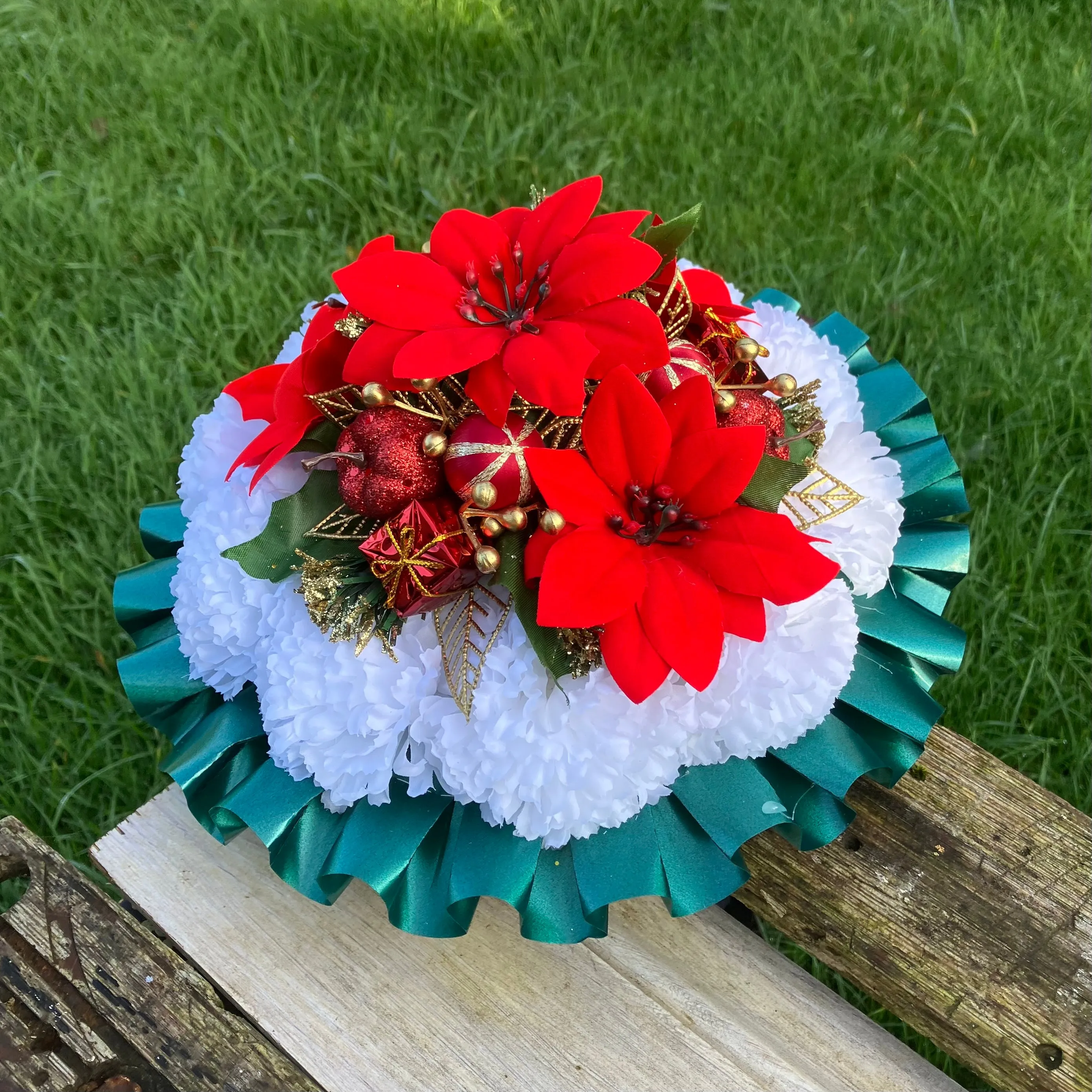 a memorial Christmas grave side posy of red poinsettia & baubles