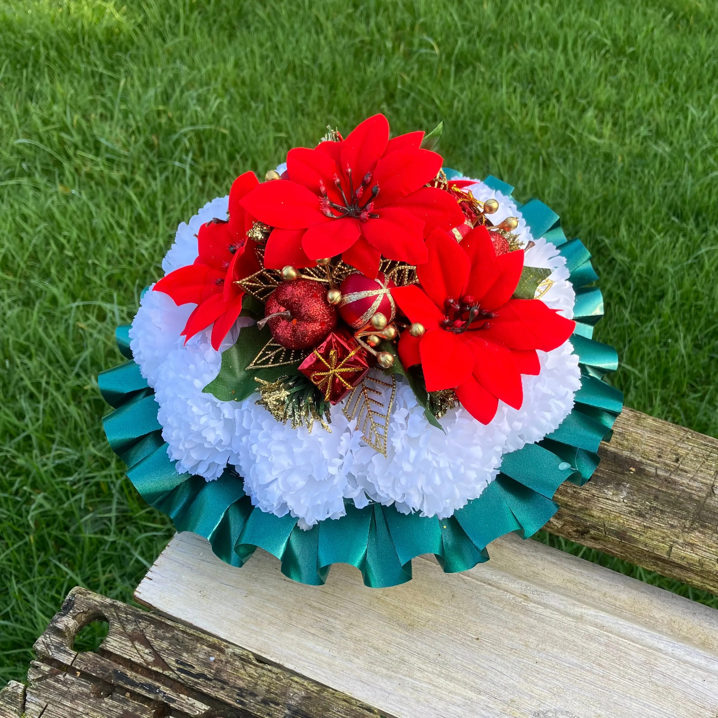 a memorial Christmas grave side posy of red poinsettia & baubles